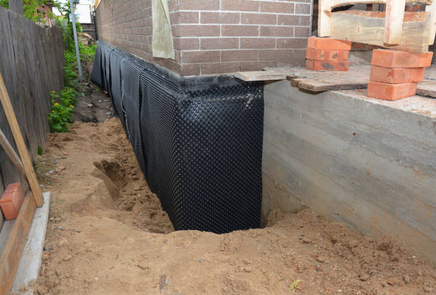 Happy homeowners after waterproofing job in Harrison
